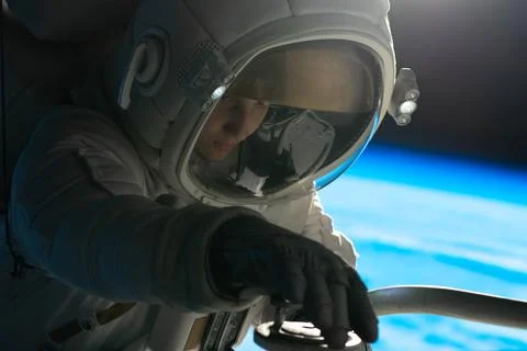 Astronaut performing spacewalk, working on a outer part of a space craft Foto stock