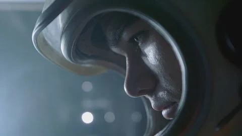 Astronaut pilot preparing for a mission in a high-tech environment with focused Stock Footage 288423310