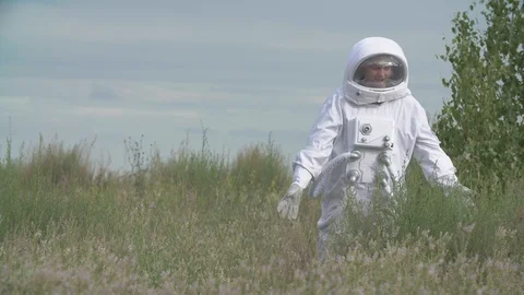 Astronaut returned to earth on the background of nature Video stock 111374310