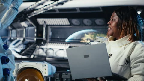 Astronaut returning from planet surface takes helmet off, talking with colleague Stock Footage 311082769