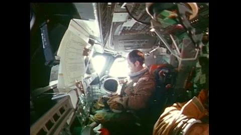 Astronaut Robert Crippen placing helmet into cloth bag aboard Space Shuttle Stock Footage 270937331