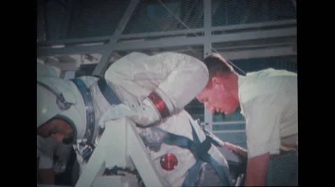 Astronaut sitting on couch with technicians assisting Stock Footage