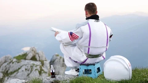 Astronaut sitting reading newspaper Stock Footage 110702652