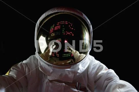 An astronaut in space making adjustments to a control panel Stock Photos