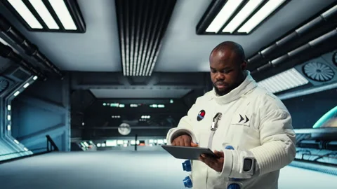 Astronaut in spacecraft using tablet to track stars and asteroids patterns Stock Footage 311898527