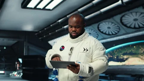 Astronaut in spacecraft using tablet to track stars and asteroids patterns Stock Footage 311962797