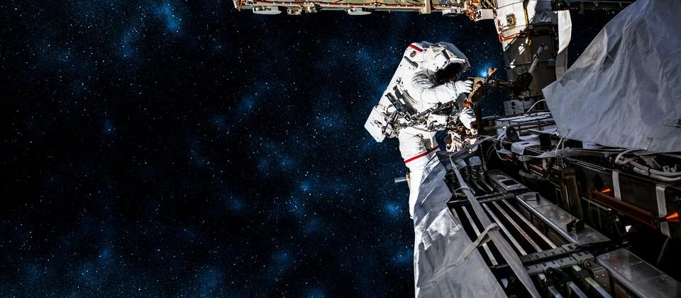 Astronaut spaceman do spacewalk while working for space station Stock Photos
