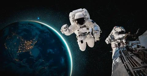 Astronaut spaceman do spacewalk while working for space station Stock Photos