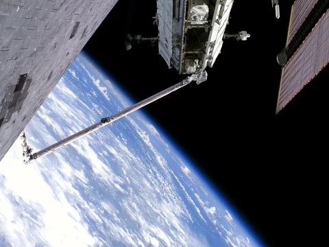 Astronaut Spacewalk on Robotic Arm From Shuttle Working on ISS, 4K Stock-Footage 75691250