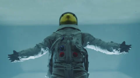 Astronaut spreading hands and falling into bright path or opened hatch. Sci-fi Stock Footage 218453818