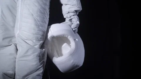 Astronaut stands and holds a helmet in his hand Stock Footage 123742502