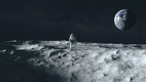 An astronaut stands on the surface of the moon among craters against the Stock Footage 144626431