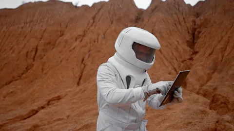 The astronaut is trying to fix a non-working tablet Stock Footage 222790821