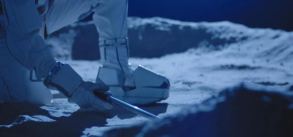 Astronaut using equipment to collect samples Stock Photos