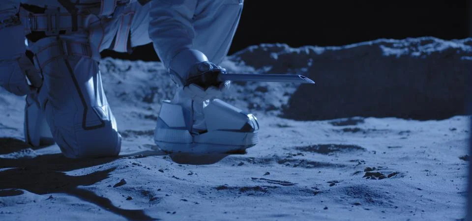 Astronaut using equipment to collect samples Stock Photos