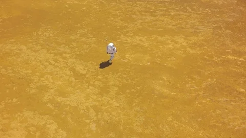 Astronaut walking alone to the edge of a cliff on Mars Stock Footage 104201129