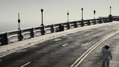Astronaut walking alone on empty road near railing and street lamps Stock Footage 341788103