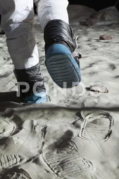 An astronaut walking on the moon, rear view, low section Stock Photos