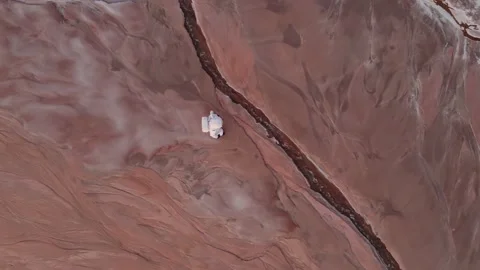 Astronaut is walking on an unknown planet. found water. aerial photography 스톡 동영상 159665677