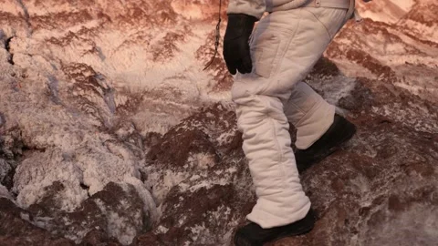The astronaut walks cautiously on the surface of the planet. walk on the rocks Video stock 159669560