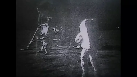 Astronauts from Apollo 11 walk on the moon as people watch everywhere on earth. Video stock 123365223
