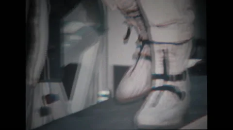Astronauts boots and then he is sitting on spacecraft couch Stock Footage 37597053