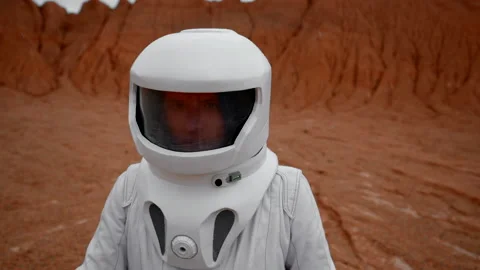 Astronaut's face in cosmic helmet close up in unknown planet's crater Stock Footage 220118329