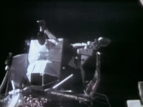 Astronauts John Watts Young and Charles Moss Duke drive a Lunar Roving Vehicle Stock Footage 79458664