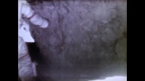 Astronauts John Watts Young and Charles Moss Duke discover an enormous rock, as Video stock 86138236