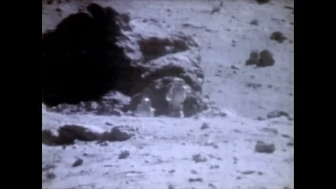 Astronauts John Watts Young and Charles Moss Duke discover an enormous rock, as Video stock 86138243