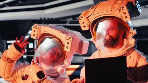 Astronauts operating starship control interface react to alien presence Stock Photos