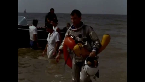 Astronauts parasail and train in a pool with a spacecraft and they are lifted by Stockbeeldmateriaal 92627012