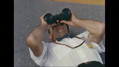 Astronauts watch the Saturn Apollo launch through binoculars - 1964 Stock Footage 104330433