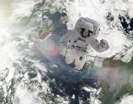 Astronauts work on satellite elements of this image furnished by nasa Stock Photos