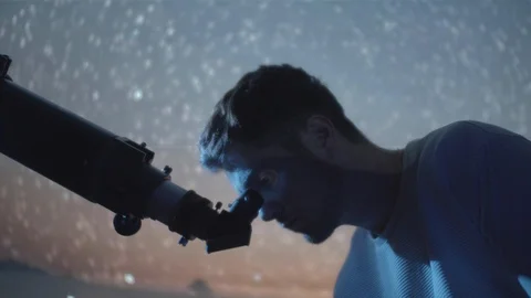 Astronomer Man in moonlight looking at sky using telescope with stars swirlin Video stock 107360536