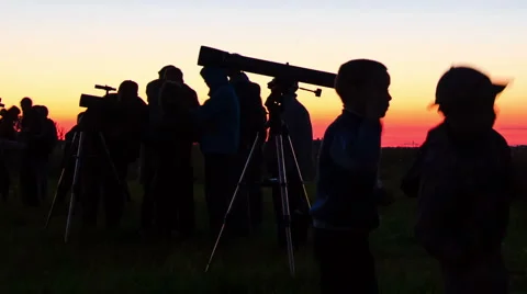 Astronomers looking through a telescope Stock Footage