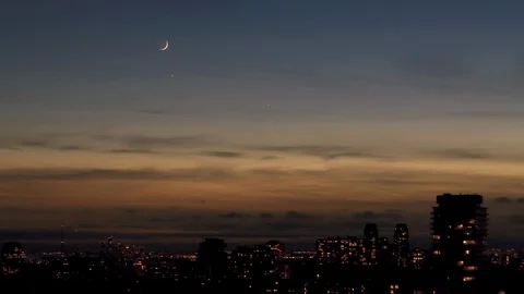 Astronomical Conjunction of Crescent New Moon Venus and Jupiter Setting in Dusk Stock Footage 120576764