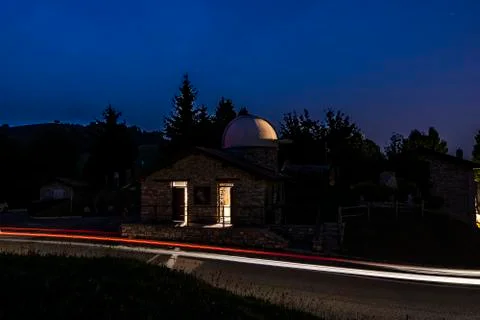 Astronomical observatory located on a side of a road with light trails of car Stock Photos