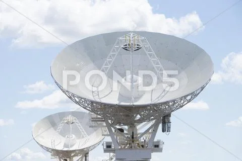 Astronomical telescope dishes at blue sky Stock Photos