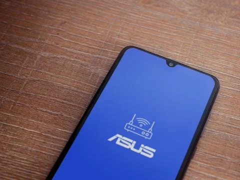 ASUS Router app launch screen on smartphone on wooden background Stock Photos