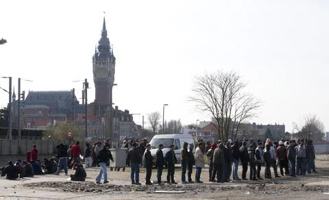 Asylum Seekers In Calais France Queue For Food Handouts Distributed By Local Cha Stock Photos