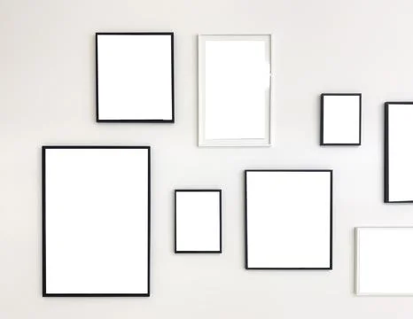 Asymmetric gallery wall arrangement with empty picture frames of various size Stock Photos