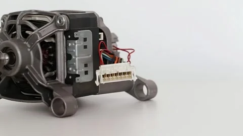 Asynchronous electric motor from a washing machine on a white background, close Stock Footage 289524873