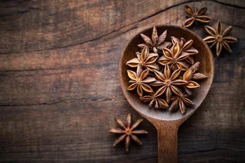 Atar anise in a spoon on dark rustic wooden background. Overhead view Stock Photos