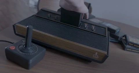 Atari 2600 with cartridge is turned on Stock Footage 154482868