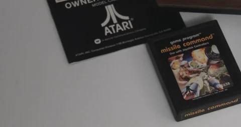 Atari 2600 Game Cartridges In Front Of Game Console - Pan Stock Footage 85965948