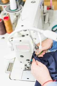 Atelier process needle detail. Unrecognizable woman hand on a sewing machine Stock Photos
