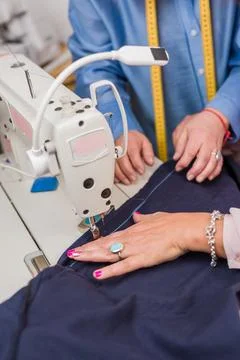 Atelier process needle detail. Unrecognizable woman hand on a sewing machine Stock Photos
