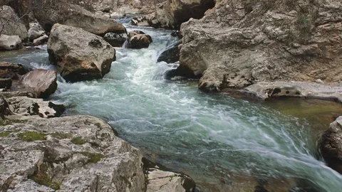 The Aterno river flows among the rocks Stock Footage 126058564
