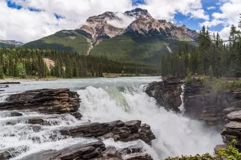 Athabasca Falls with cloudy sky Stock Photos